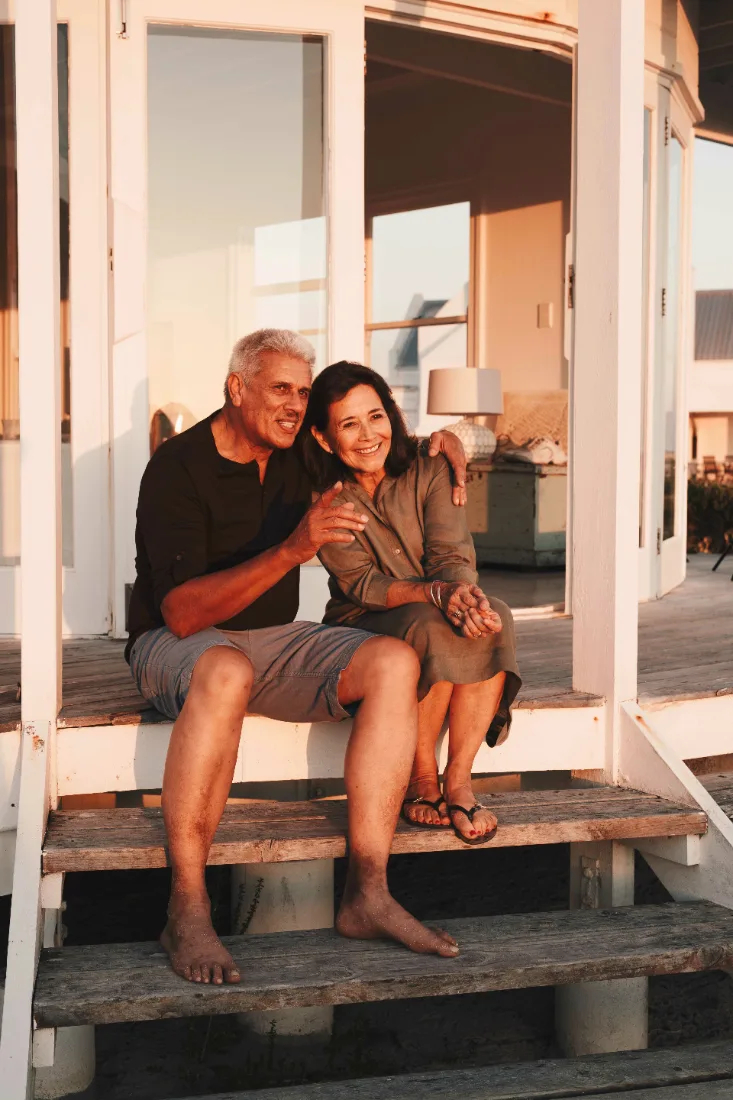 Couple on the porch steps at sunset